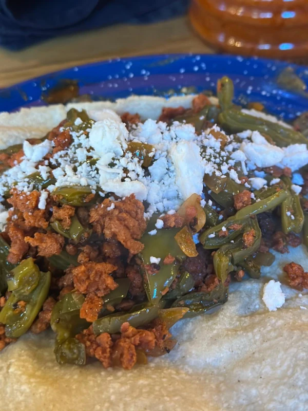 Nopales with pork and red sauce